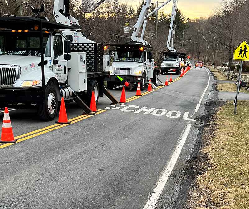 clearway industries equipment and crew on roadway clearing trees and limbs from utility lines
